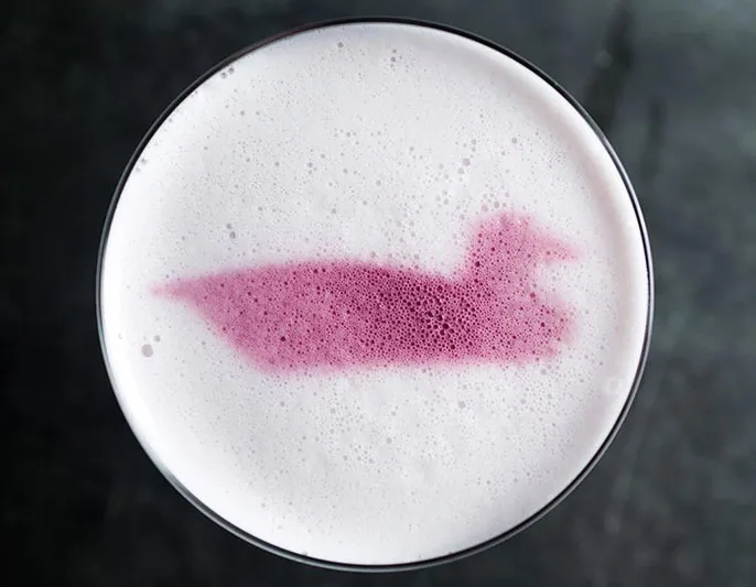 Cocktail with a duck motif in the foam at Decoy
