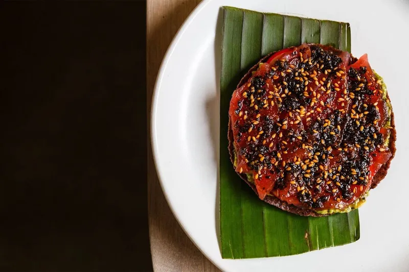Charred round dish presented on a banana leaf at Oxomoco