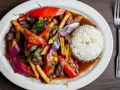 Lomo Saltado, sautéed beef with peppers, onions and french fries served with white rice, at Pio Pio