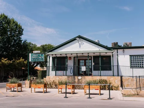 White-washed exterior and forecourt of Joe T. Garcia's