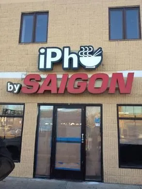 Exterior storefront sign reading 'iPho by Saigon' above the entrance at 704 University Ave W, Saint Paul