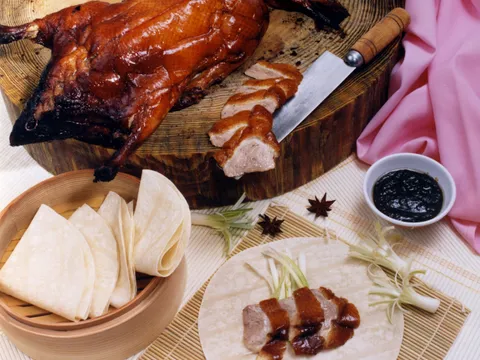 Whole roast Peking duck at Sang Kee, sliced, served with steamer pancakes, scallions and hoisin sauce