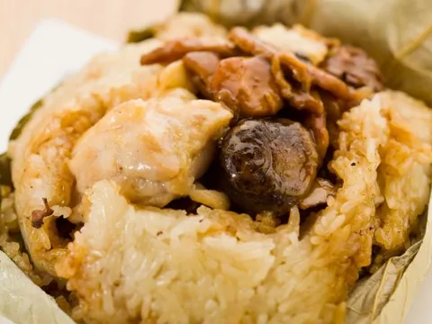 Sticky rice parcel opened on a plate at Tim Ho Wan