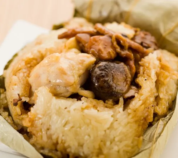 Sticky rice parcel opened on a plate at Tim Ho Wan