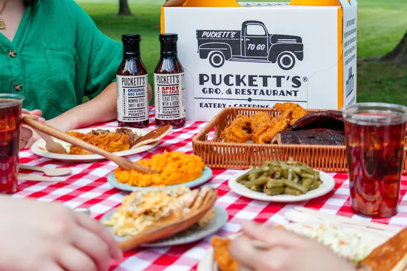 Fried chicken, ribs, and sides in a Puckett's to-go pack