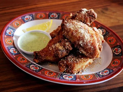 Fried chicken with a dipping sauce on a patterned plate at MAKfam