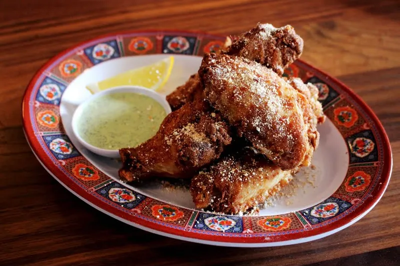 Fried chicken with a dipping sauce on a patterned plate at MAKfam
