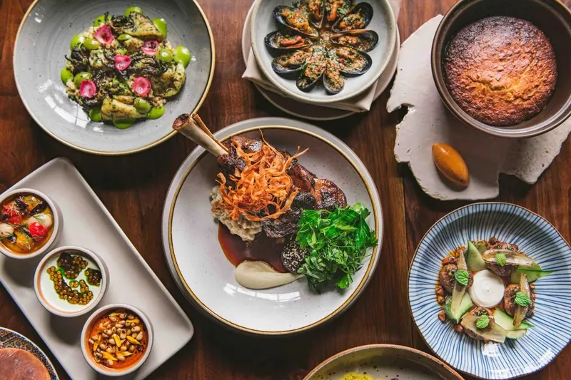 Spread of Moroccan dishes including lamb, mussels, breads and vegetables at Aziza