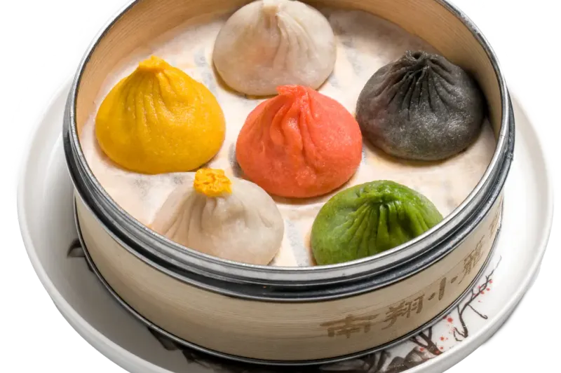 Steamer of multicoloured soup dumplings at Nan Xiang