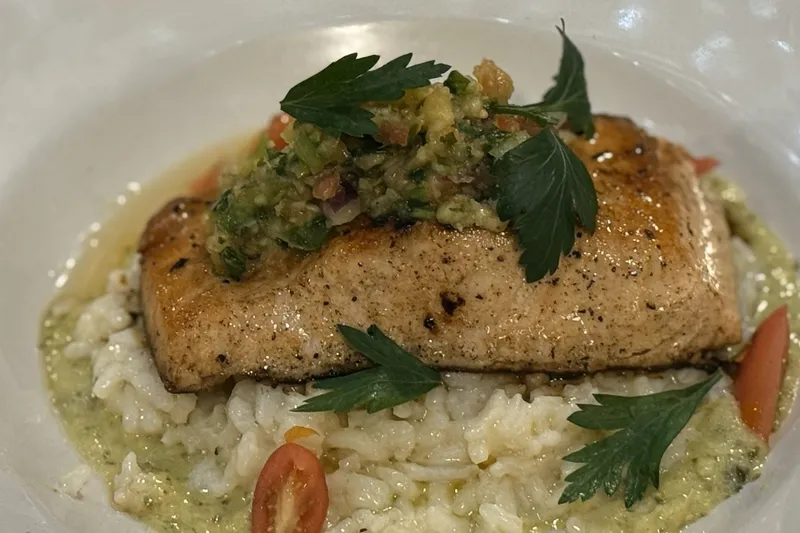 Seared fish over risotto with salsa verde at Aroma Restaurant