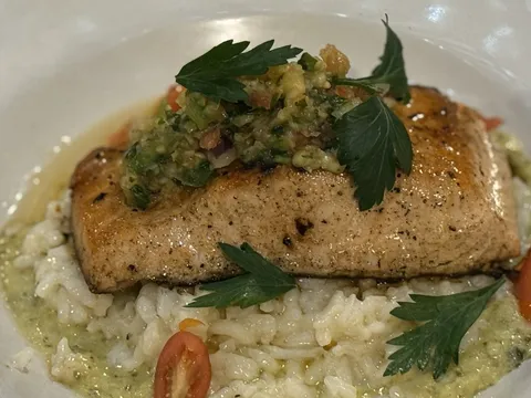 Seared fish over risotto with salsa verde at Aroma Restaurant