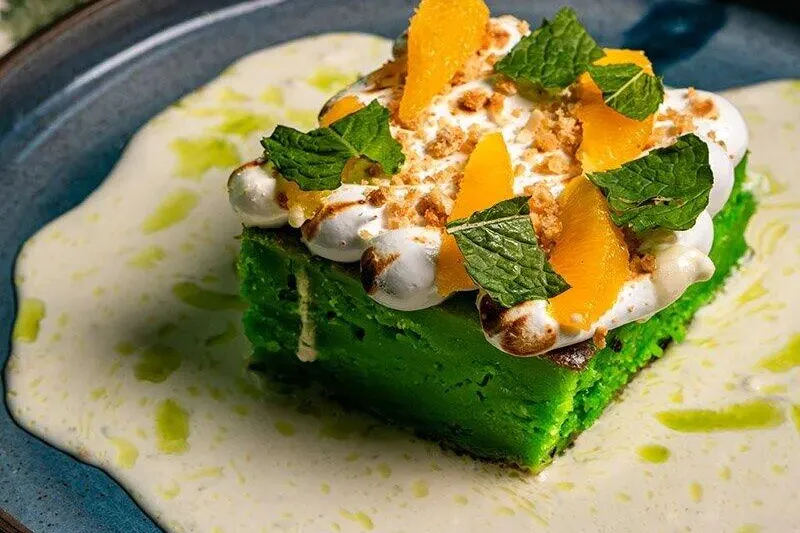 Green dessert topped with citrus, cream and mint at Lucky Danger