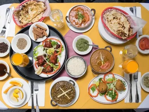 Assorted dishes including naan, tandoori chicken, and curries at Ekta Indian Cuisine