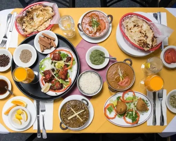 Assorted dishes including naan, tandoori chicken, and curries at Ekta Indian Cuisine