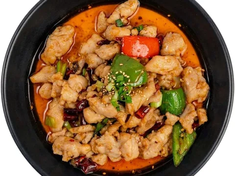 Sichuan diced chicken stir-fried with dried chilies and bell peppers in red chili oil, a dish served at Petals of a Peony in Memphis