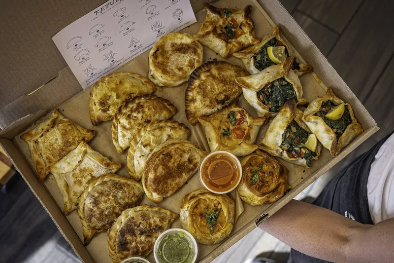 Box of freshly baked empanadas from Rincon Argentino