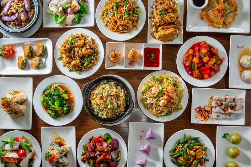 Overhead spread of Cantonese dishes at Jing Fong