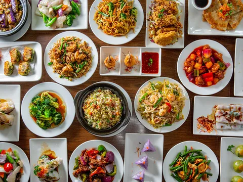 Overhead spread of Cantonese dishes at Jing Fong