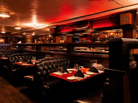 Dining room booths and bar at The Golden Ox steakhouse
