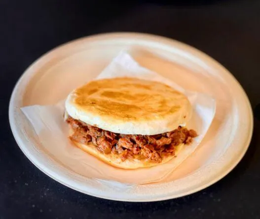 Rou jia mo — stewed pork in a griddled flatbread bun on a plate at Xi'an Gourmet House