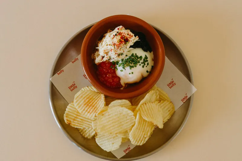 Small plate with chips, roe, egg, and crab at Little Belly
