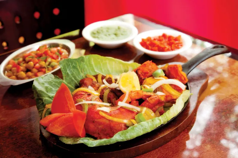 Tandoori mixed grill sizzler with green and red chutneys and chana at Indian Delhi Palace