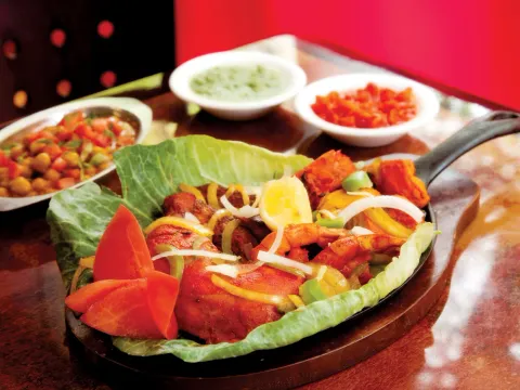 Tandoori mixed grill sizzler with green and red chutneys and chana at Indian Delhi Palace
