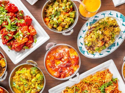 Overhead spread of Nepali and Indian curries, rice, bread, and appetizers at Nepal House
