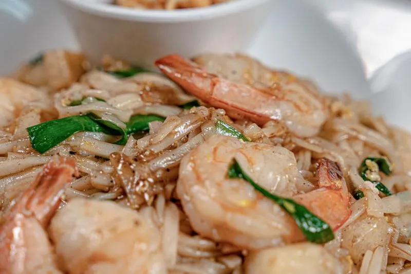 Pad Thai with shrimp and a side bowl of crushed peanuts at All Thai'd Up in Louisville