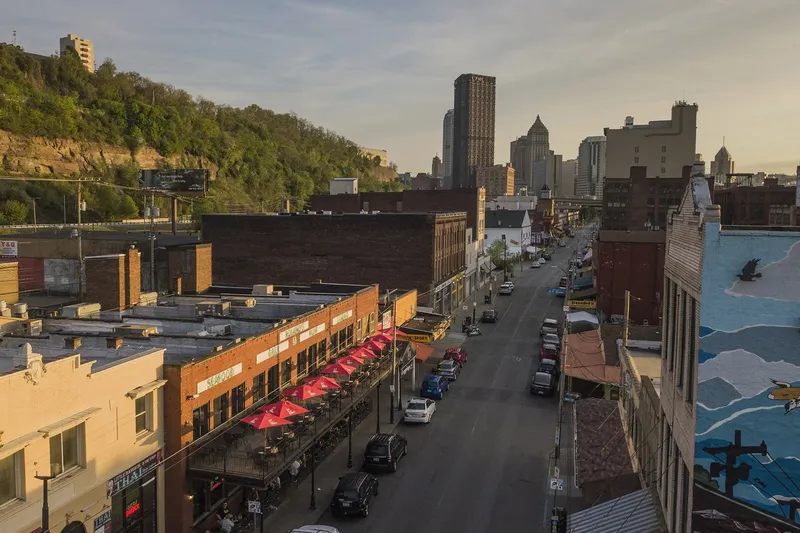 Penn Avenue streetscape in Pittsburgh's Strip District with Roland's Seafood Grill's outdoor patio