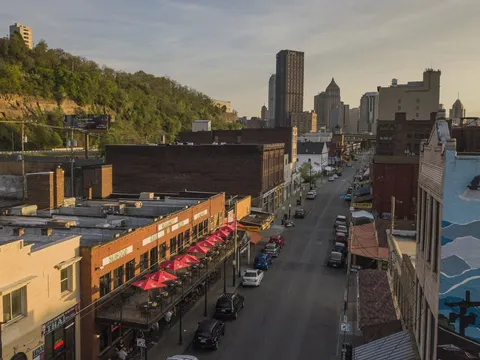 Penn Avenue streetscape in Pittsburgh's Strip District with Roland's Seafood Grill's outdoor patio