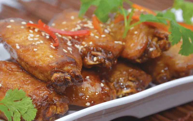 Platter of roast poultry garnished with chili and cilantro at Dragon Beaux