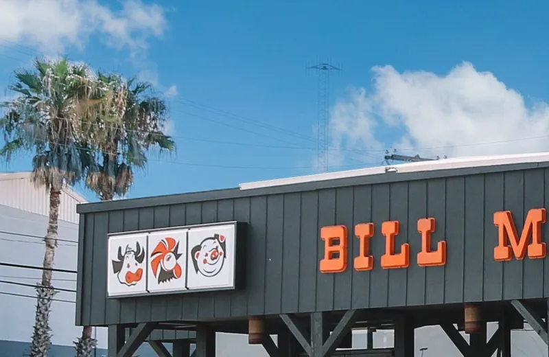 Bill Miller Bar-B-Q's roadside sign against a blue sky
