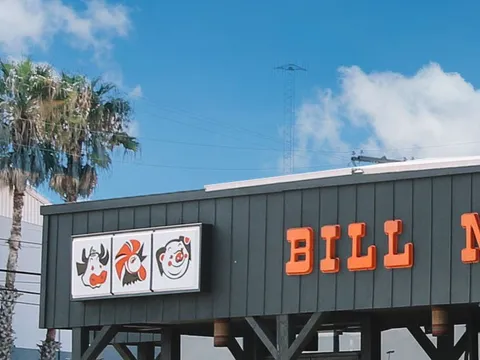 Bill Miller Bar-B-Q's roadside sign against a blue sky