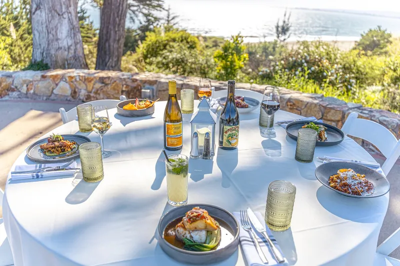 Ocean-view patio table set for dinner at Sanderlings Restaurant