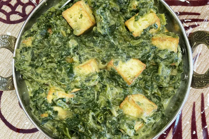 Palak paneer served in a copper karahi at India Kutir