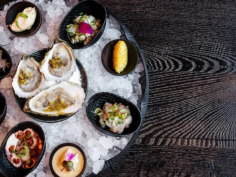 Bacchanalia fruits de mer seafood tower on crushed ice with oysters, shrimp, octopus and crudos