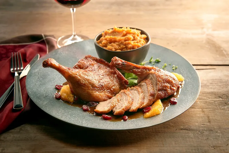 Plated crispy duck with sweet potato mash and red wine at Grand Concourse in Pittsburgh