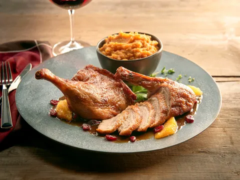 Plated crispy duck with sweet potato mash and red wine at Grand Concourse in Pittsburgh