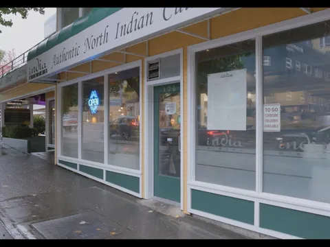 Green-trimmed storefront of India Bistro on Roosevelt Way in Seattle