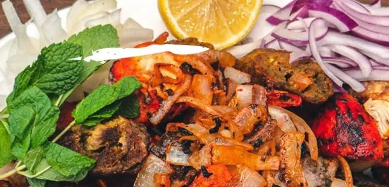 A platter of grilled tandoori meats and vegetables from City of Spice.