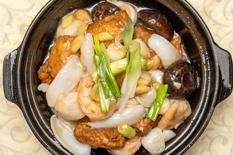 Clay pot of seafood with prawns, squid, scallops, fried tofu and shiitake mushrooms at East Ocean Seafood Restaurant