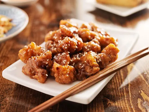 Crispy glazed chicken served on a white platter at Taiwan Cafe