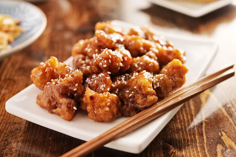 Crispy glazed chicken served on a white platter at Taiwan Cafe