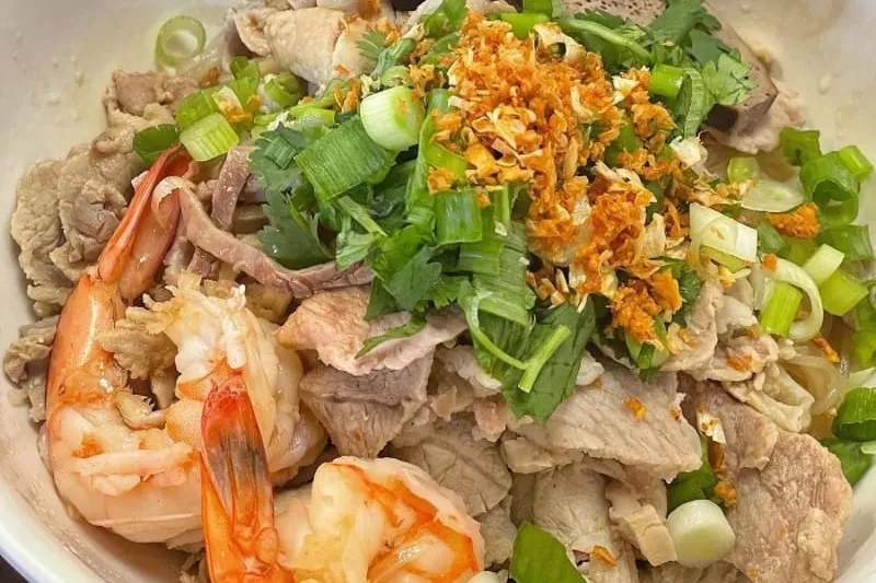 The Phnom Penh Noodle House Special at Phnom Penh Noodle Shack — a bowl of noodles topped with sliced pork, shrimp, liver, scallions, cilantro and crispy fried garlic