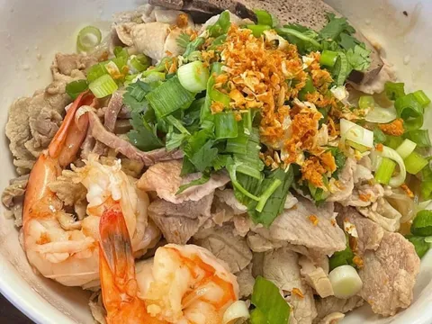 The Phnom Penh Noodle House Special at Phnom Penh Noodle Shack — a bowl of noodles topped with sliced pork, shrimp, liver, scallions, cilantro and crispy fried garlic