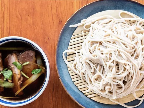 Kamonegi handmade soba noodles served beside duck dipping broth