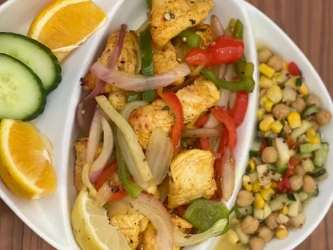 Tandoori chicken tikka platter with sautéed peppers and onions and a chickpea salad at Seva Cuisine of India