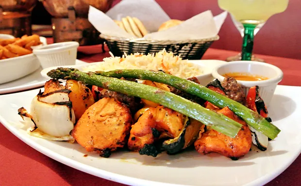 Tandoori mixed grill platter with chicken tikka, seekh kebab, grilled asparagus, onions and rice at Bombay Olive