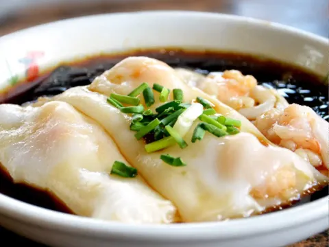 A shrimp rice noodle roll (cheong fun) topped with chopped chives in sweet soy sauce at Yin Ji Chang Fen